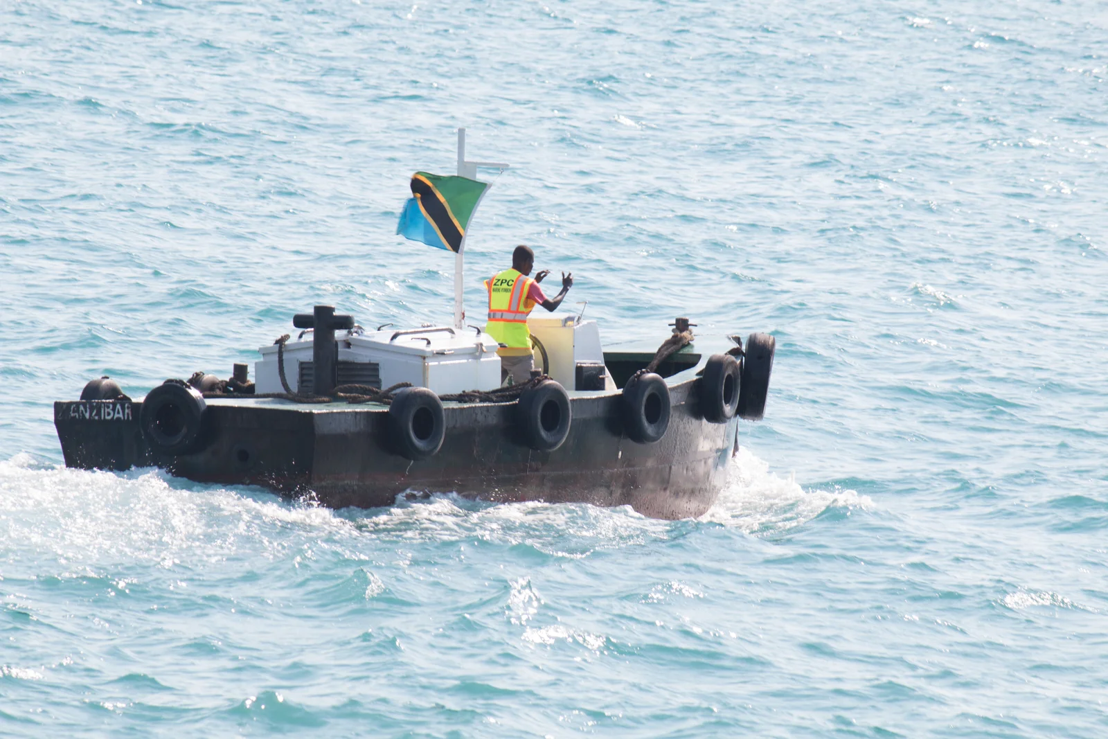 Barca di legno a motore che attraversa il canale poco profondo da Kilwa Masoko a Kilwa Kisiwani