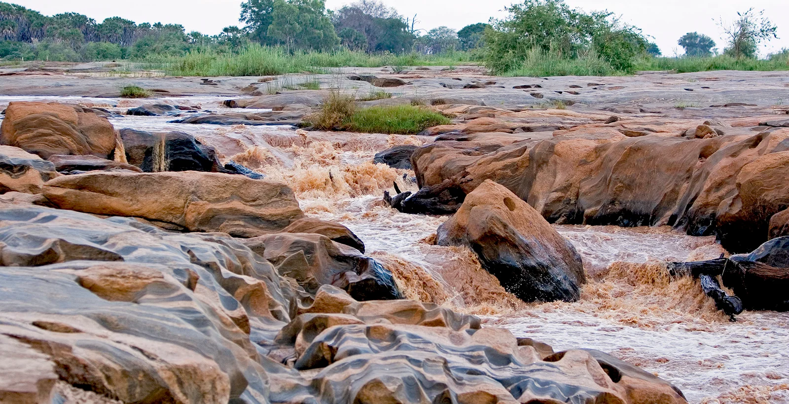 Lugard Falls – die Stromschnellen aus Granit und Orthogneis am Galana-Fluss mit erodierten Felsrinnen