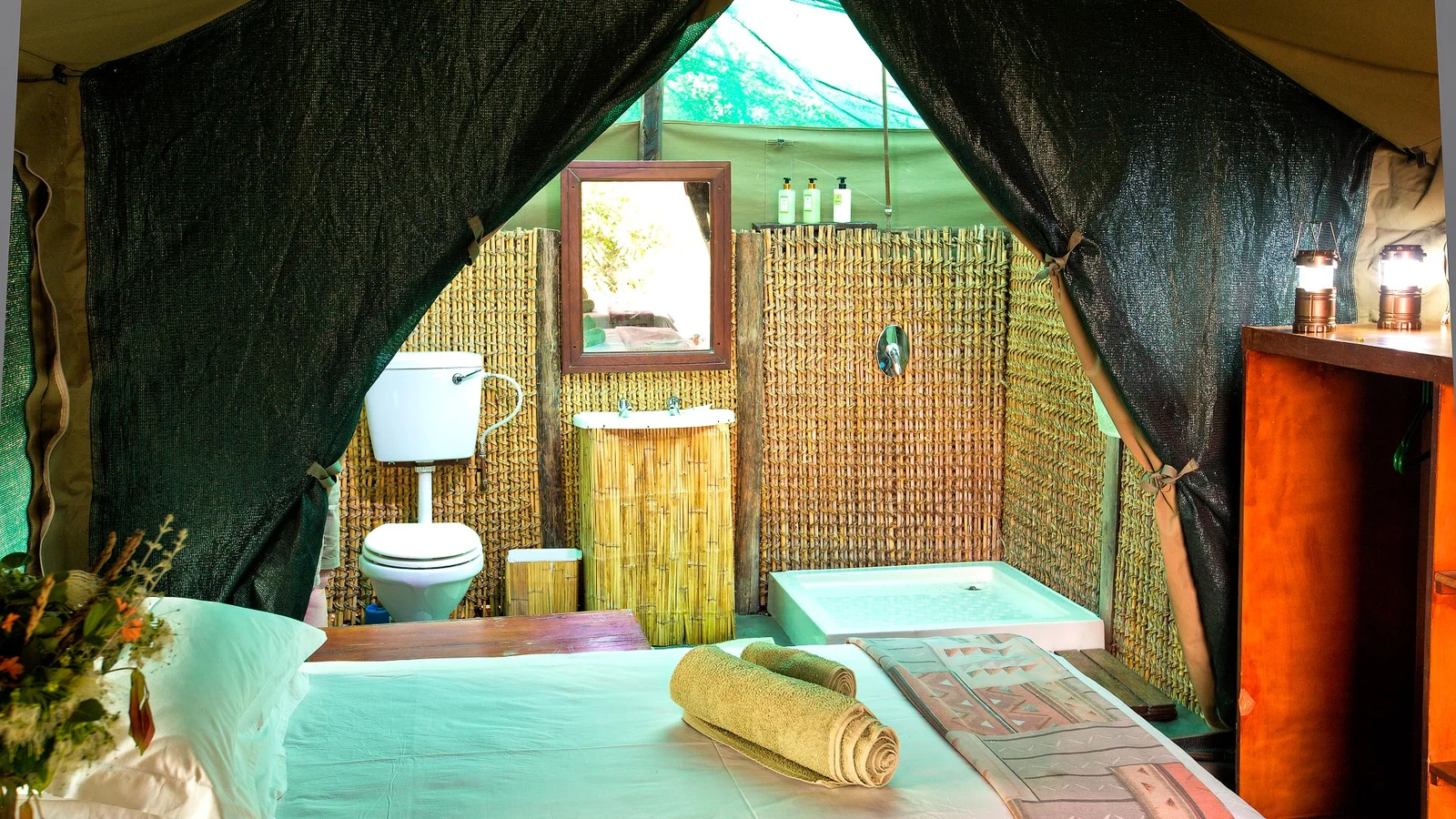 Interior of a tented room at Udzungwa Forest Tented Camp with simple furnishings