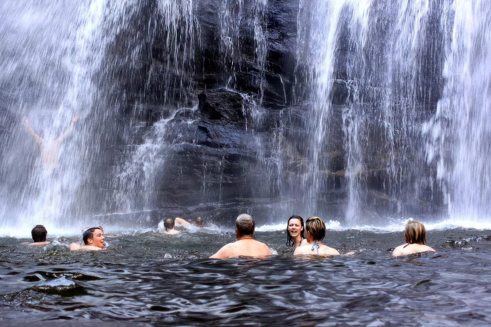 Schwimmen im kühlen Gumpen am Fuß des Sanje-Wasserfalls