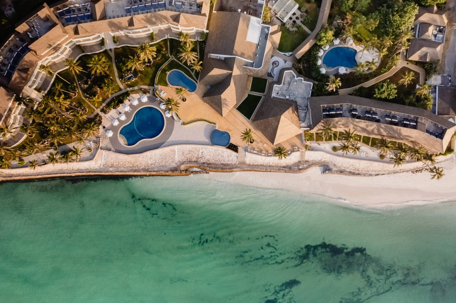 Luftaufnahme von Watamus kleinen Buchten mit dem weißen Sandstrand innerhalb der Meeresparklagune und dem Küstenwald, der bis an den Strand reicht